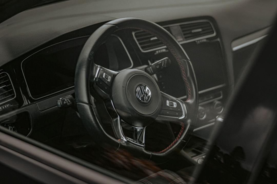 the interior of a car with a steering wheel and dashboard