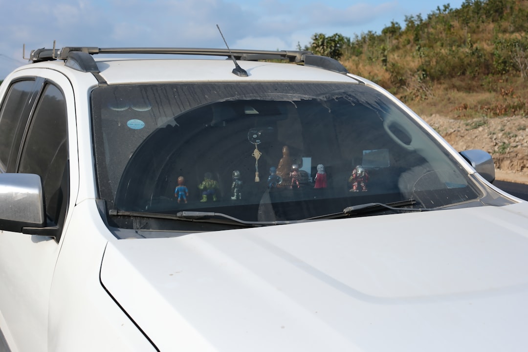 A white truck parked on the side of a road