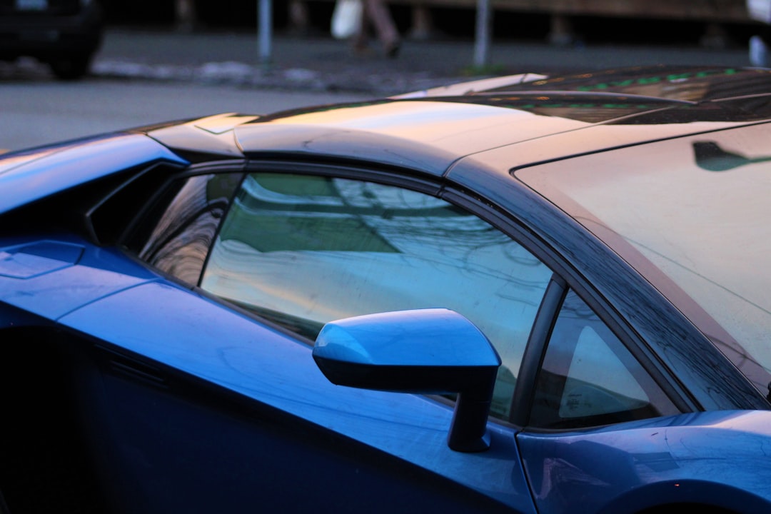 a blue car with a side mirror